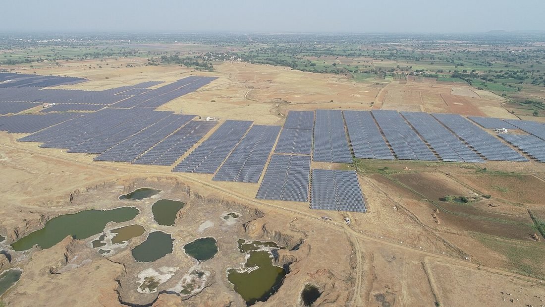Large solar farm laid out across open land, representing the scale of solar needed to run cooling loads