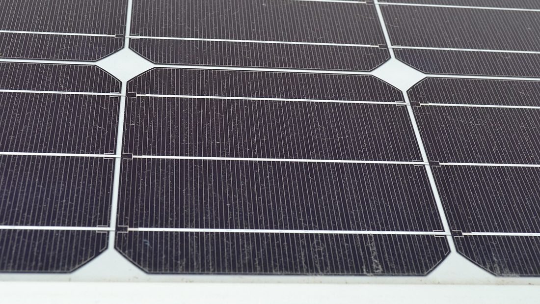 Rows of monocrystalline solar panels showing the module size used to work out how many panels a house needs