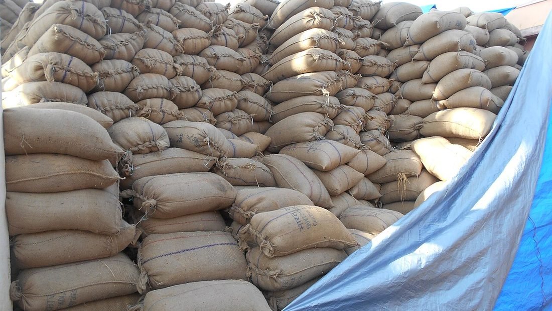 Stacked sacks of rice at an Indian rice mill, a high daytime power load that suits rooftop solar in Chhattisgarh