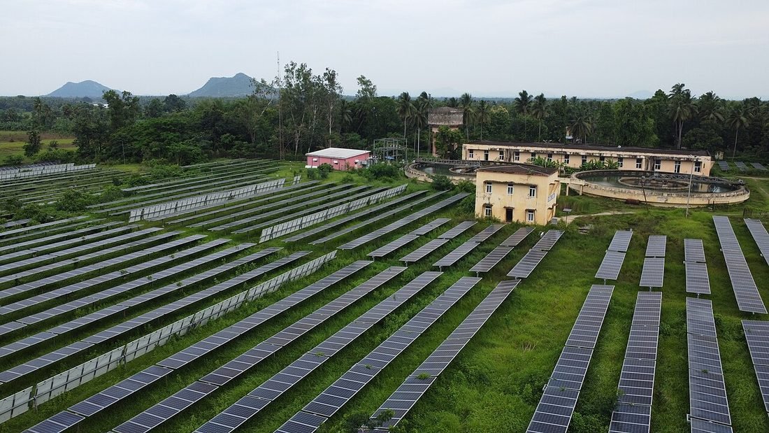 Aerial view of a large solar farm in India, whose panels slowly degrade over a 25-year life