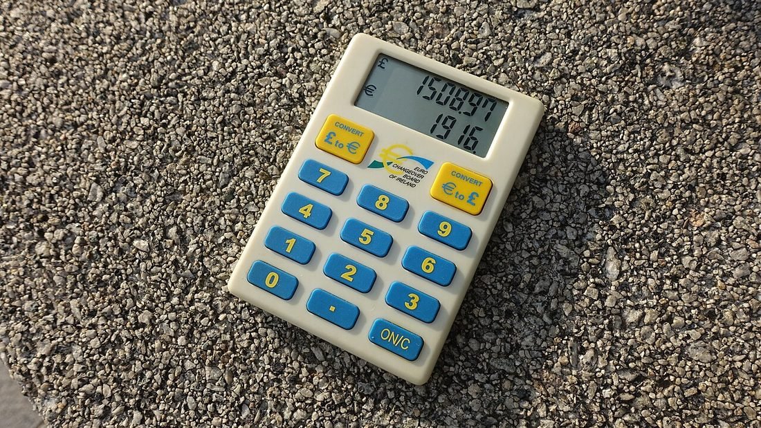 Pocket calculator on gravel, representing the calculation of solar payback period for a rooftop system