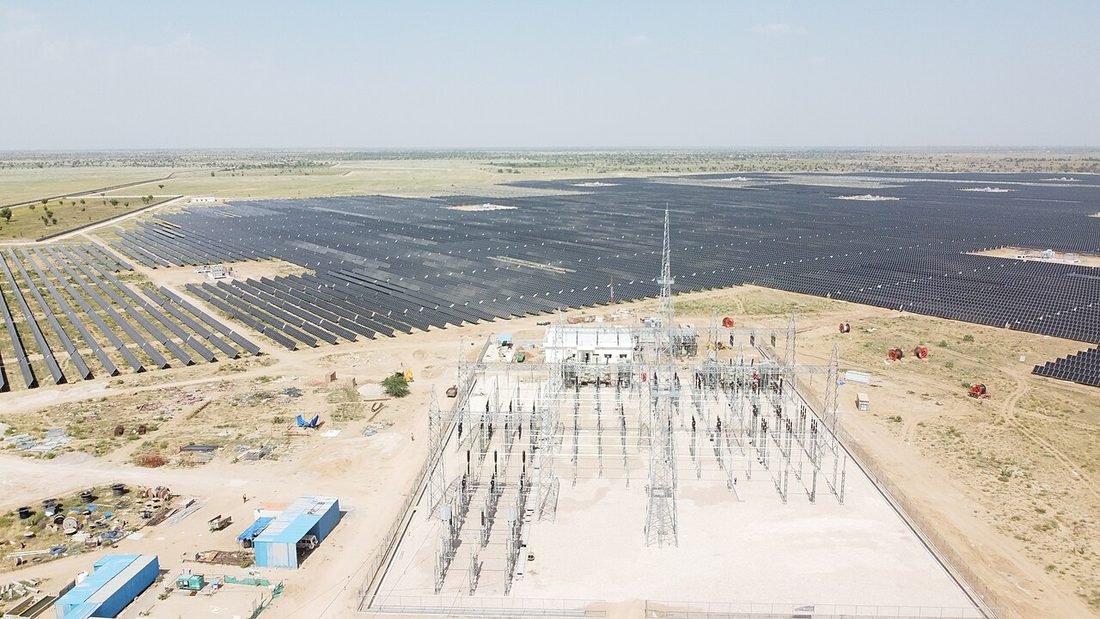 Large solar power plant with a substation in India, a reminder that real solar projects have documentation and verification