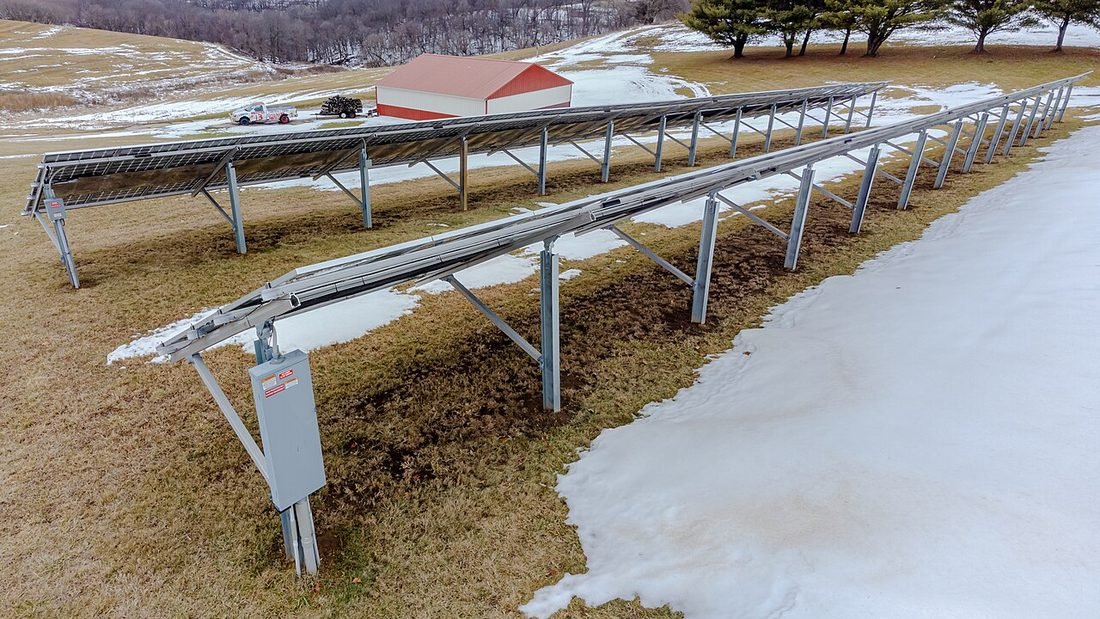 Ground-mounted solar array with fixed racks, representing solar power compared with a conventional inverter and battery set